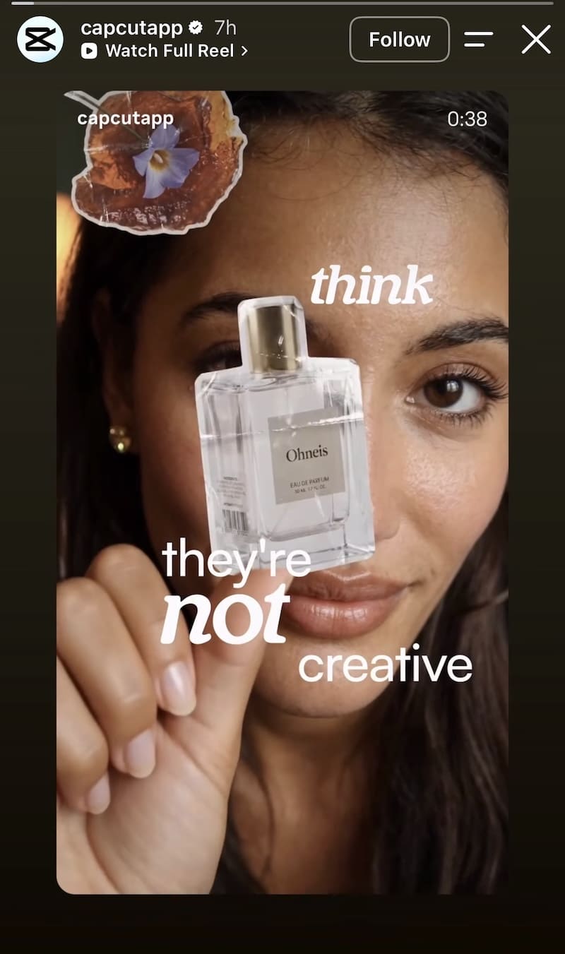 Woman holds perfume bottle close to face, fragmented 'they're NOT creative' animated text on dark background.