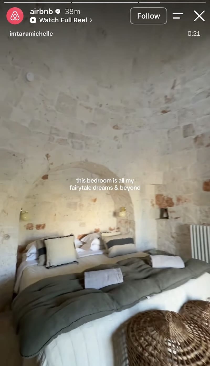 Creator films trullo bedroom with stone vaulted ceiling and linen bedding, fairytale dreams caption overlaid.